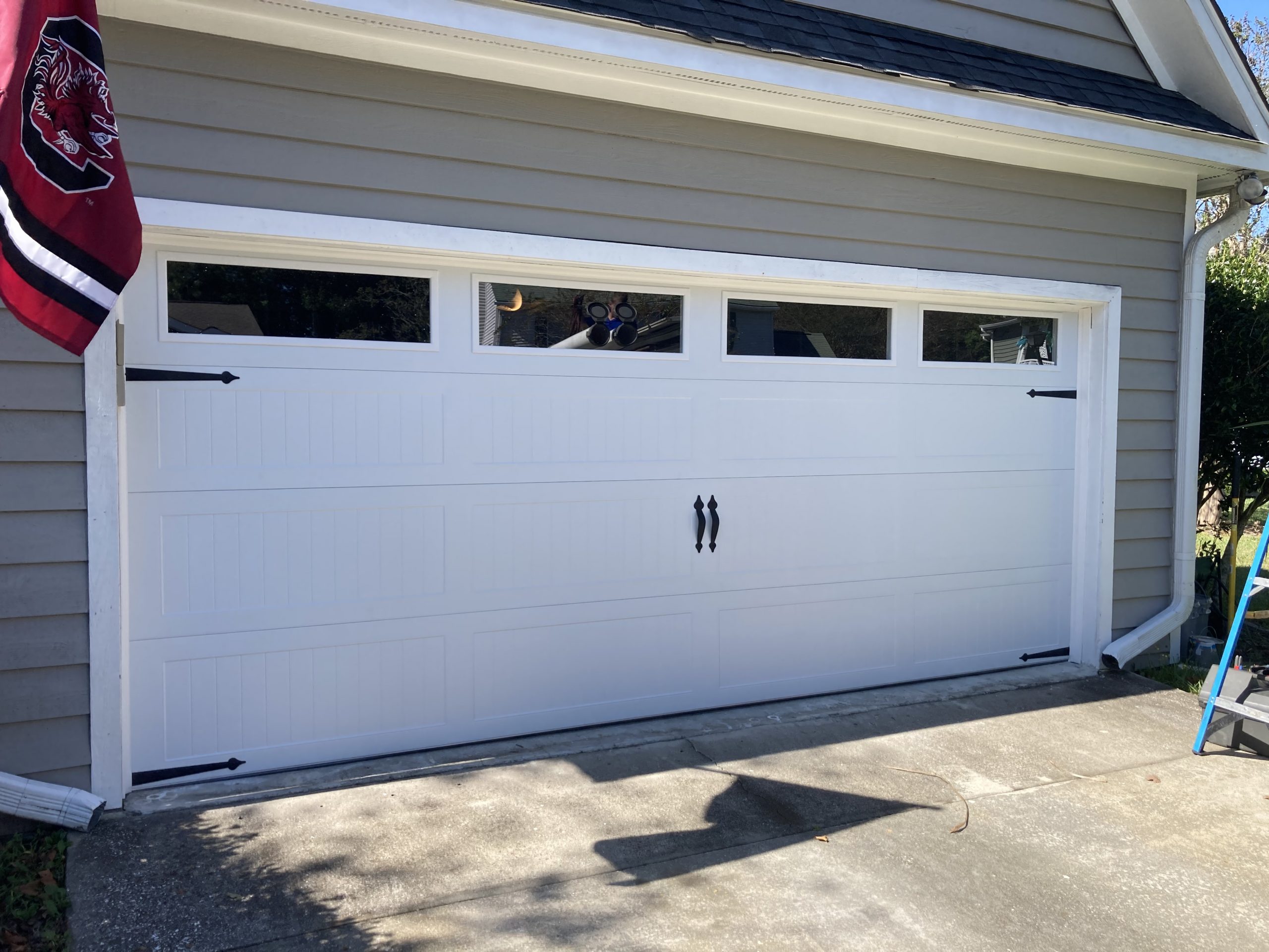 White CHI garage door with handles and windows
